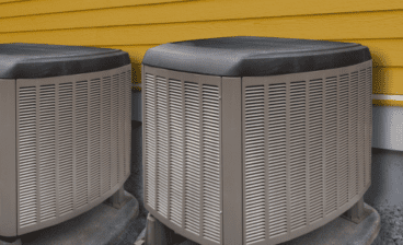 two outdoor residential HVAC systems